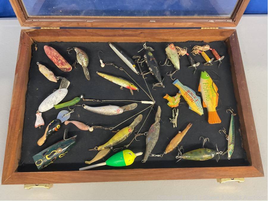 Wooden fishing lures in display case Auction